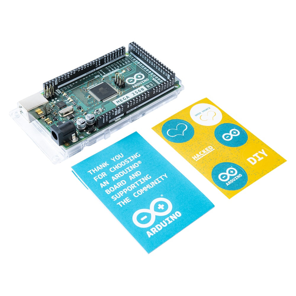 Arduino MEGA 2560 Rev3 microcontrolador board with black PCB, USB port, and pin headers beside colorful Arduino stickers for . - Arduino MEGA 2560 Rev3 - Microbot México - Default Title